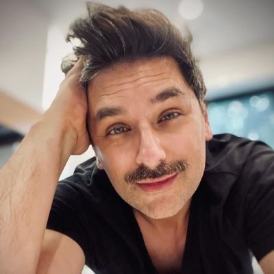 Mark Ghanime taking a selfie with a mustache.